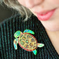 The Graceful Green Sea Turtle Brooch (2023) by Erstwilder and Pete Cromer
